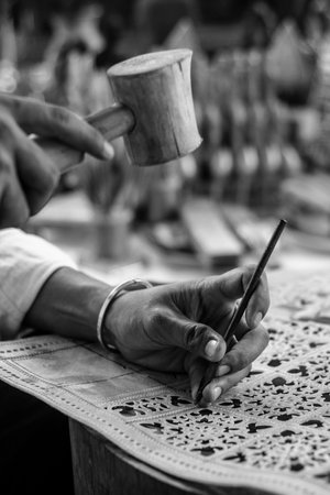 craft artist making traditional buffalo leather carving art in indonesiaのeditorial素材
