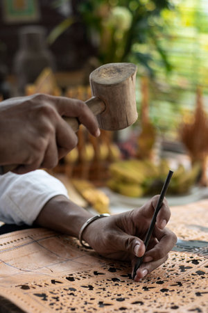 craft artist making traditional buffalo leather carving art in indonesiaのeditorial素材