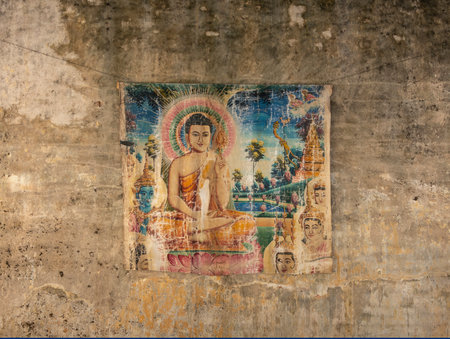 old painted print of buddha on decayed wall in cambodia asiaのeditorial素材