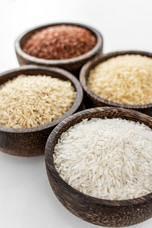different kinds of asian rice grains in bowls on white background in Cambodiaの写真素材