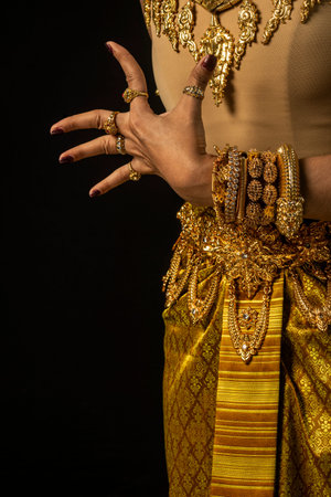 close detail of Khmer apsara performer costume and traditional dance on black background in cambodiaの写真素材
