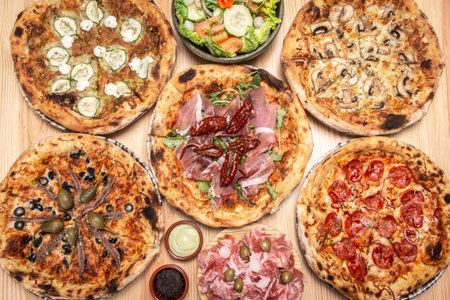 mixed different traditional italian pizzas meal on restaurant table