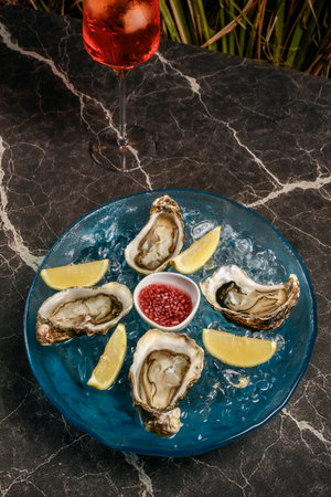 fresh galician raw oysters dish on ice in gourmet vigo restaurant table in spainの写真素材
