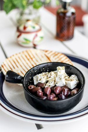 marinated olives and feta cheese mediterranean tapas snack at outdoor restaurant in mykonos greece