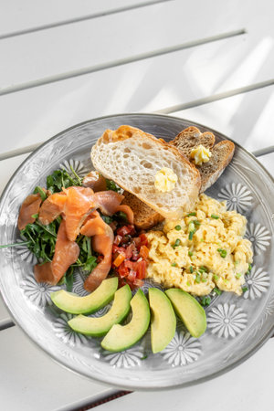 smoked salmon with avocado salad and scrambled eggs healthy breakfast plate in Melbourne Australia...