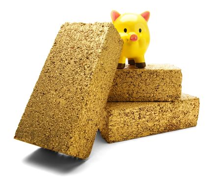 Piggy bank on gold bricks isolated over whiteの写真素材