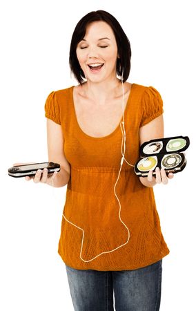 Smiling woman listening to music on an media player isolated over whiteの写真素材