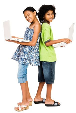 Young boy and girl holding laptops and smiling isolated over whiteの写真素材