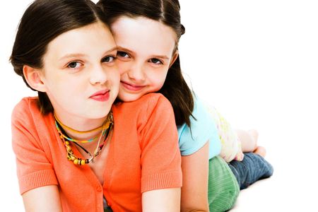 Girls posing and smiling together isolated over whiteの写真素材