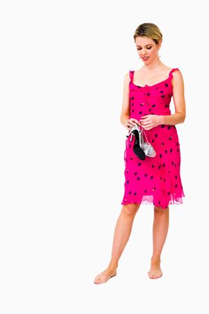 Woman holding high heels and thinking isolated over whiteの写真素材