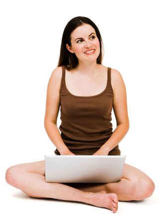 Beautiful woman using a laptop and thinking isolated over whiteの写真素材