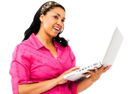Smiling young woman using a laptop isolated over whiteの写真素材