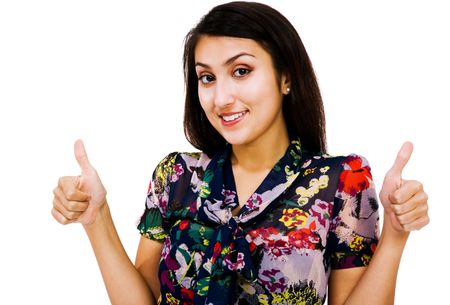 Confident woman showing thumbs-up sign and smiling isolated over whiteの写真素材