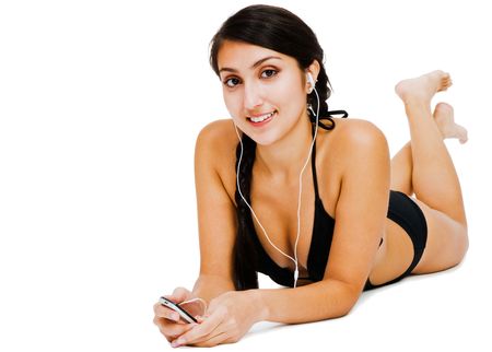 Happy woman listening to music on MP3 player isolated over whiteの写真素材