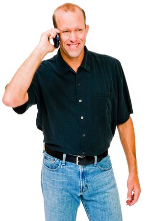 Smiling man talking on a mobile phone isolated over whiteの写真素材