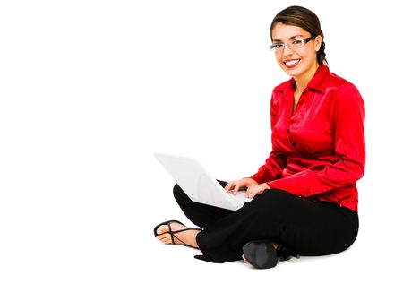 Confident woman using a laptop and smiling isolated over whiteの写真素材