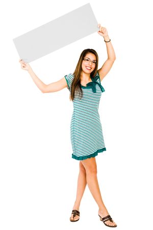 Smiling woman showing a placard and posing isolated over whiteの写真素材