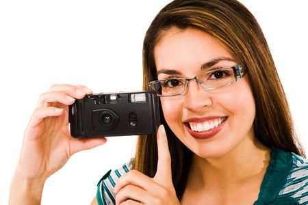 Fashion model photographing with a camera and smiling isolated over whiteの写真素材