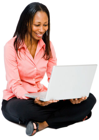 Close-up of a woman using a laptop and smiling isolated over whiteの写真素材