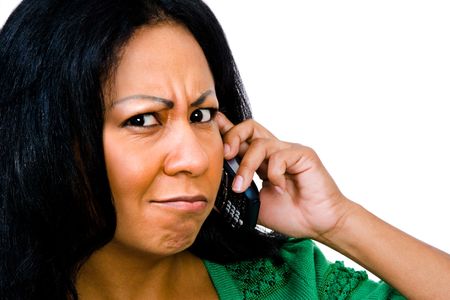 Fashion model talking on a mobile phone isolated over whiteの写真素材