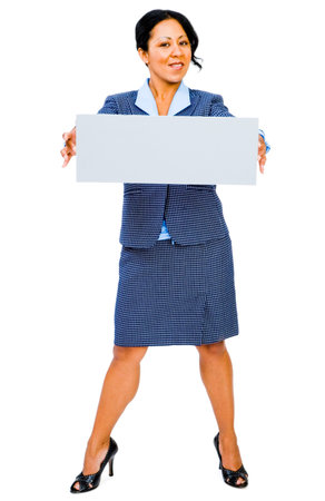 Confident businesswoman showing a placard and posing isolated over whiteの写真素材