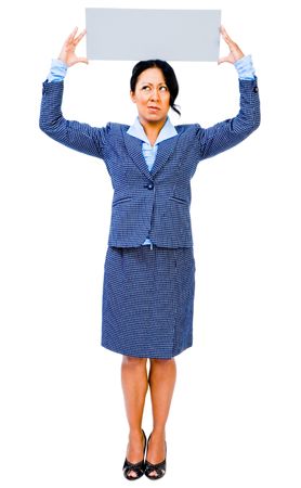 Mid adult businesswoman showing a placard and thinking isolated over whiteの写真素材