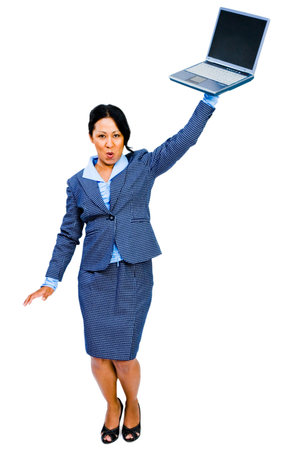 Woman holding a laptop and posing isolated over whiteの写真素材