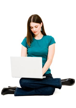 Young woman using a laptop isolated over whiteの写真素材