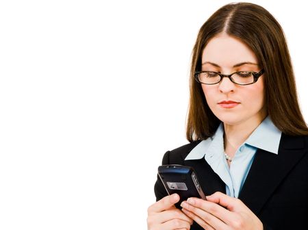 Businesswoman holding a mobile phone and text messaging isolated over whiteの写真素材