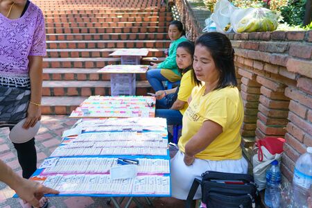 Chiangmai, Thailand - 13 October 2018: Thai People with disabilities are selling lottery tickets to the people who passed by to pay homage to Wat Phrathat Doi Suthep.のeditorial素材