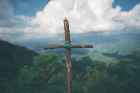 The cross with nature in the forest on the hill is the Blackground.の写真素材