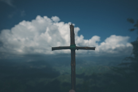 The cross with nature in the forest on the hill is the Blackground.の写真素材