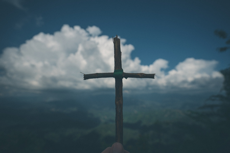 The cross with nature in the forest on the hill is the Blackground.の写真素材
