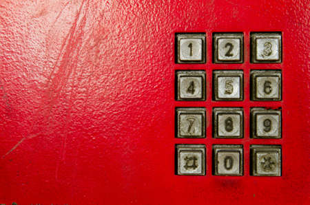 An old red public telephone panel の写真素材
