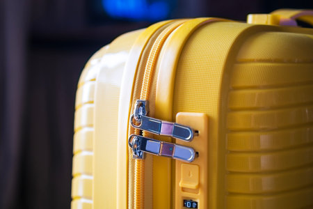 securely locked bright yellow suitcase. close upの写真素材