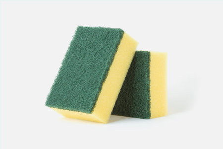 Yellow and green scrub sponge for dish washing isolatedの写真素材