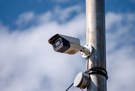 A CCTV camera is mounted on a pole. High quality photoの写真素材