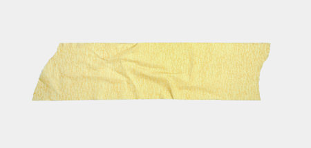 A strip of bright yellow paper tape on a clean white surfaceの写真素材