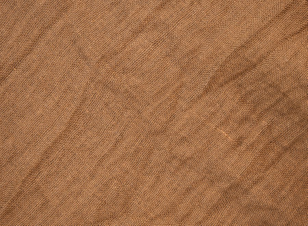 This fabric displays a rich texture and warm brown tones with subtle patterns.の写真素材