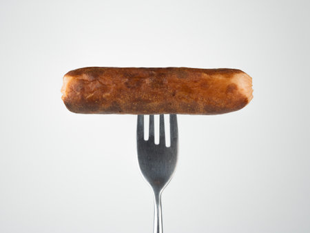 grilled sausage on a fork isolatedの写真素材