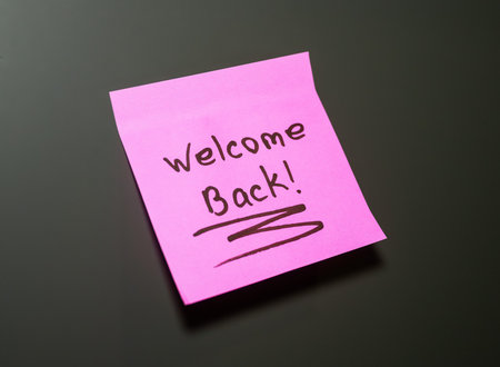 Colorful sticky note displays a cheerful welcome back message for someone returning