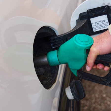 Fueling a car at a gas station in daylightの写真素材