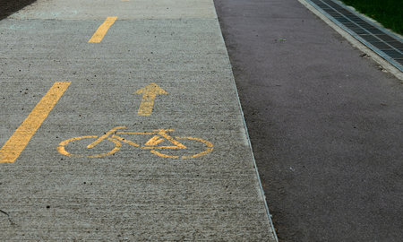 Concrete walkways feature distinct bicycle lane markings for cyclistsの写真素材