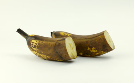 Ripened bananas on a plain background. bananas cut in halfの写真素材