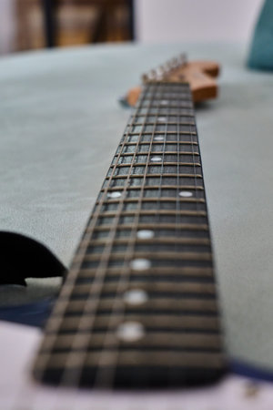 Detailed view of a guitar neck featuring frets and strings.