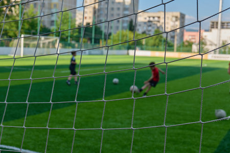 Children enjoy kicking a soccer ball on a grassy field. High quality photoの写真素材