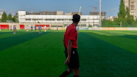 Referee officiating a football match on a sunny dayの写真素材