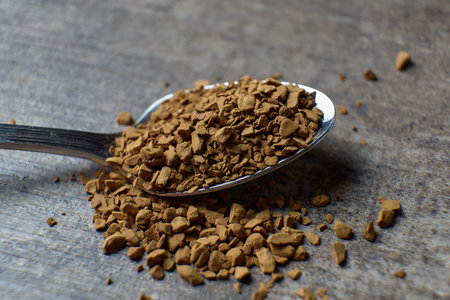 Instant coffee granules on a spoon. close up view