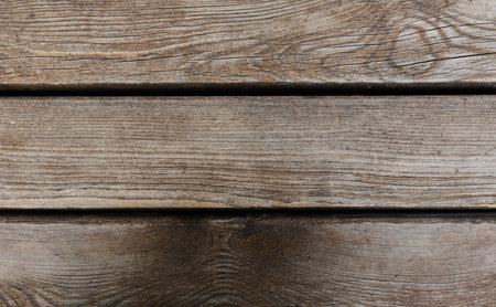 Detailed texture of rustic wooden planks in warm tonesの写真素材
