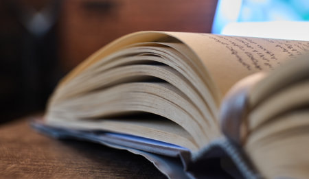 Open book on a wooden table in soft light. High quality photoの写真素材